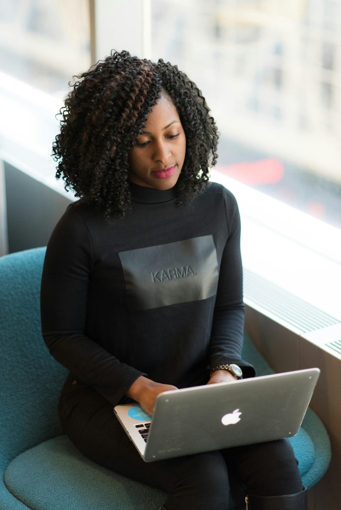 pexels photo 1181214 1181214 Confident woman using a laptop in a bright office environment, symbolizing modern professional life.
