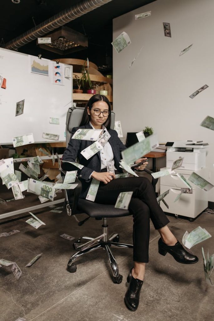 Demo Post 1 Businesswoman in modern office with falling cash, symbolizing financial success.